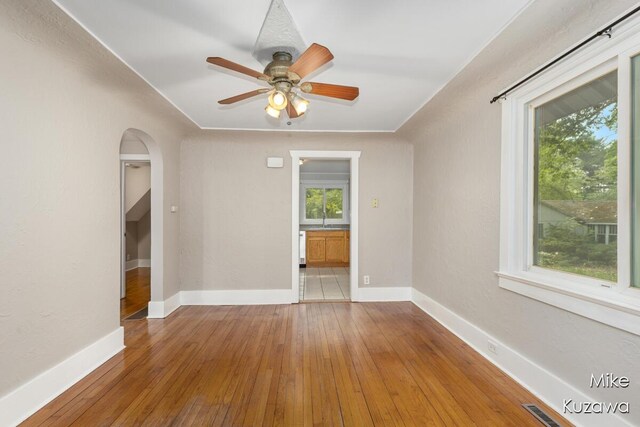 16742 148th Ave, Spring Lake, MI 49456 - spare room featuring hardwood / wood-style floors, a sink, arched walkways, and baseboards