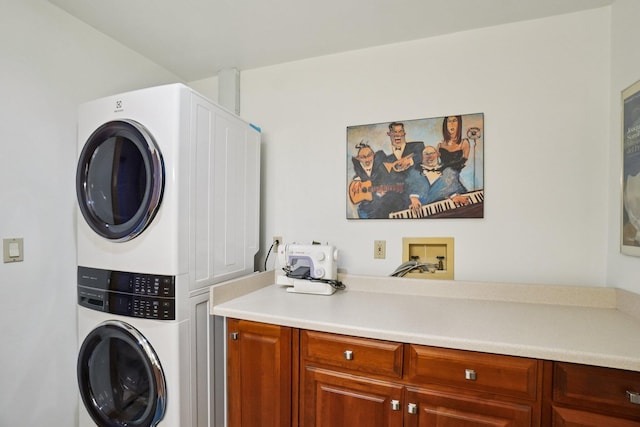 3377 Timberwood Ln, Ann Arbor, MI 48103 - washroom with stacked washer / drying machine and cabinet space