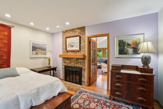 3377 Timberwood Ln, Ann Arbor, MI 48103 - bedroom featuring wood finished floors, a brick fireplace, and recessed lighting