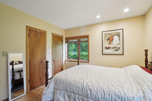 3377 Timberwood Ln, Ann Arbor, MI 48103 - bedroom with light wood-style flooring, two closets, and recessed lighting