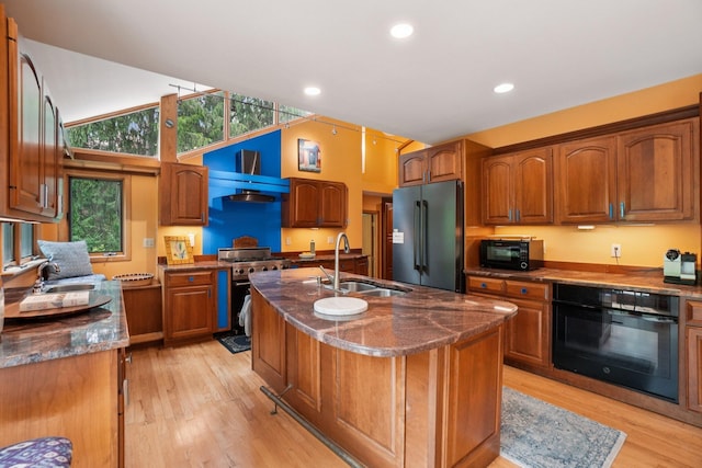 3377 Timberwood Ln, Ann Arbor, MI 48103 - kitchen featuring stainless steel appliances, a sink, dark stone countertops, light wood finished floors, and recessed lighting