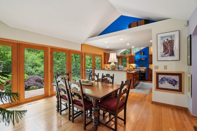 3377 Timberwood Ln, Ann Arbor, MI 48103 - dining area with lofted ceiling, light wood-style floors, and baseboards