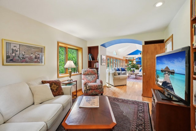 3377 Timberwood Ln, Ann Arbor, MI 48103 - living area with arched walkways, wood finished floors, and recessed lighting