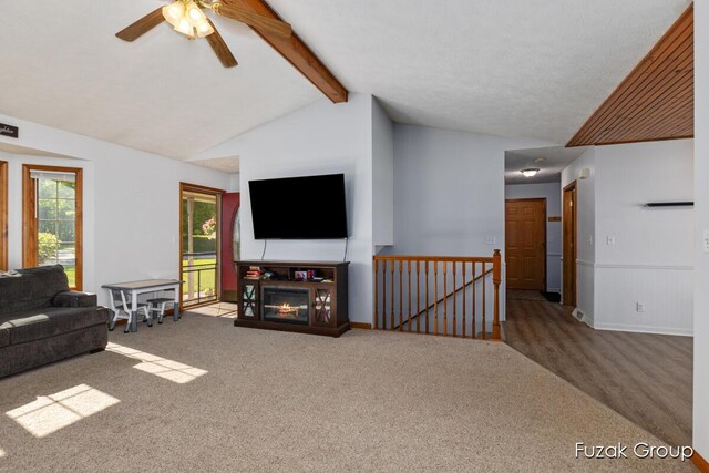 3882 40th St, Hamilton, MI 49419 - carpeted living room featuring a ceiling fan and a glass covered fireplace