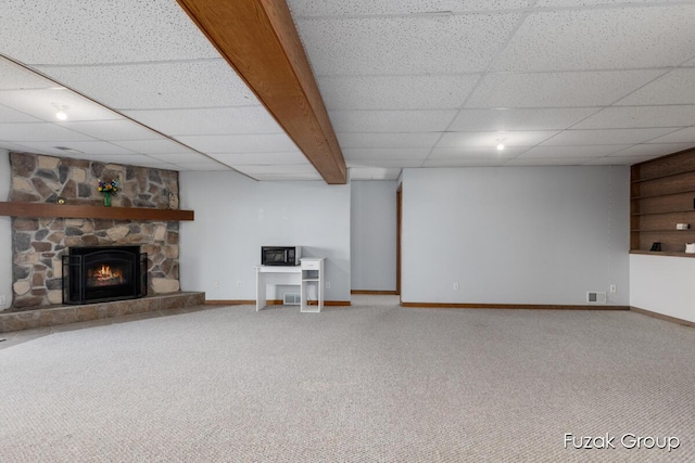 3882 40th St, Hamilton, MI 49419 - unfurnished living room featuring baseboards, carpet, a drop ceiling, and a stone fireplace