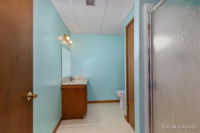 3882 40th St, Hamilton, MI 49419 - full bath featuring a drop ceiling, toilet, vanity, a shower with shower door, and baseboards