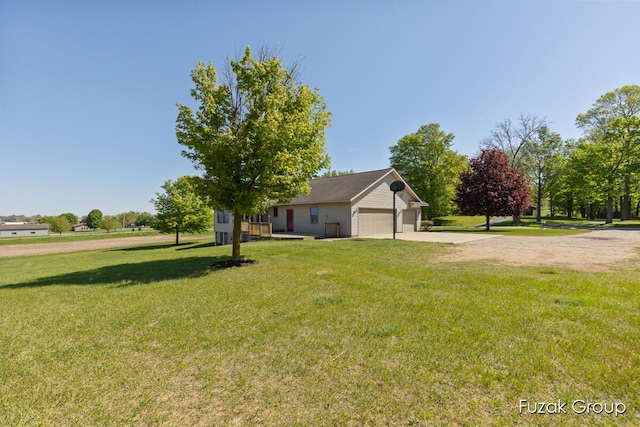 3882 40th St, Hamilton, MI 49419 - view of green lawn featuring driveway and a garage