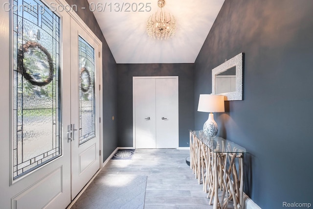 16039 Knobhill Dr, Argentine, MI 48451 - entryway with a chandelier, wood finished floors, baseboards, and lofted ceiling