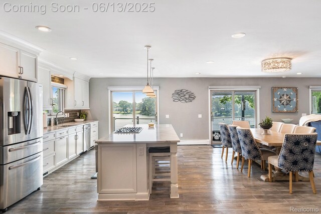 16039 Knobhill Dr, Argentine, MI 48451 - kitchen with stainless steel appliances, a sink, white cabinets, recessed lighting, and light countertops