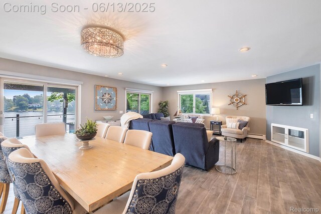 16039 Knobhill Dr, Argentine, MI 48451 - dining room featuring baseboard heating, healthy amount of natural light, wood finished floors, recessed lighting, and baseboards