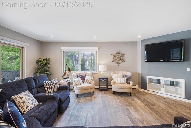 16039 Knobhill Dr, Argentine, MI 48451 - living area featuring wood finished floors, baseboard heating, recessed lighting, baseboards, and a baseboard heating unit