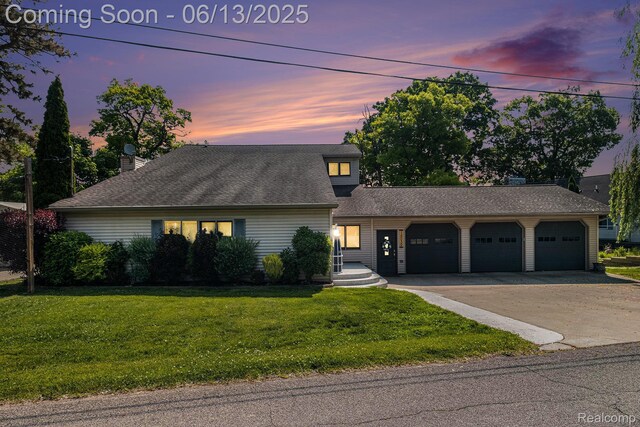 16039 Knobhill Dr, Argentine, MI 48451 - view of front facade featuring an attached garage, concrete driveway, a yard, and roof with shingles