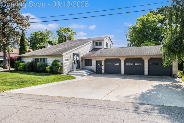 16039 Knobhill Dr, Argentine, MI 48451 - view of front of house with an attached garage, a front lawn, concrete driveway, and roof with shingles