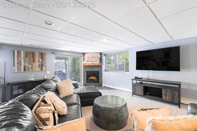 16039 Knobhill Dr, Argentine, MI 48451 - living room with baseboard heating, baseboards, a fireplace, carpet flooring, and a paneled ceiling