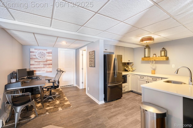16039 Knobhill Dr, Argentine, MI 48451 - kitchen with freestanding refrigerator, a sink, a drop ceiling, light countertops, and light wood-type flooring