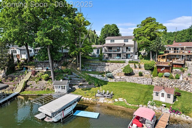 16039 Knobhill Dr, Argentine, MI 48451 - dock area with stairs, boat lift, a water view, and a lawn