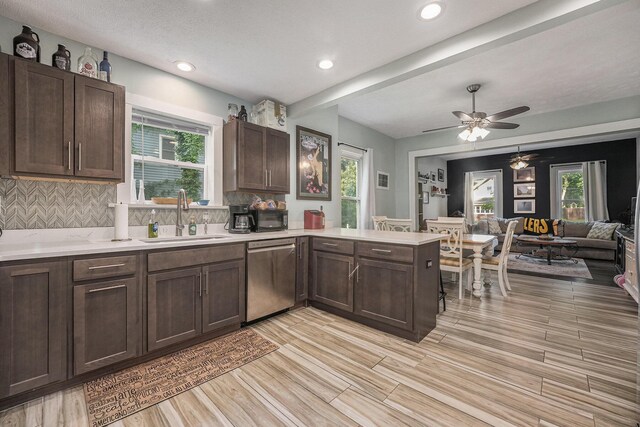 610 Union St, Ionia, MI 48846 - kitchen with a sink, dishwasher, light countertops, a peninsula, and dark brown cabinets