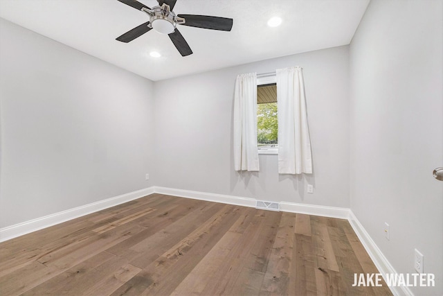 726 Gardenview Ct SW, Byron Center, MI 49315 - unfurnished room featuring baseboards, wood finished floors, a ceiling fan, and recessed lighting