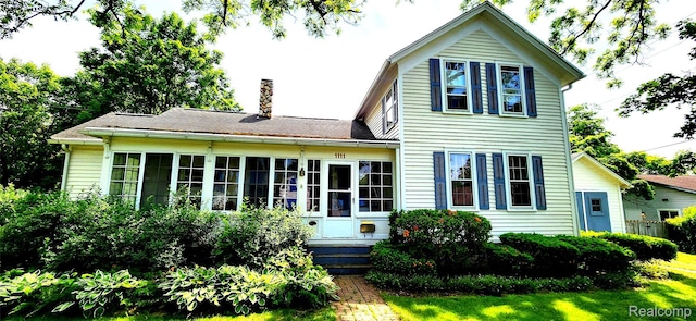1111 W Park St, Lapeer, MI 48446 - rear view of property with a chimney