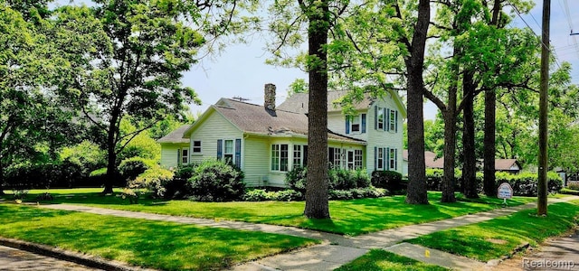 1111 W Park St, Lapeer, MI 48446 - traditional-style home featuring a front lawn and a chimney