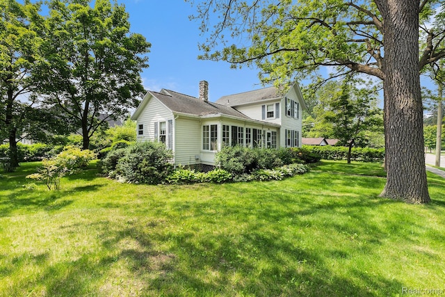 1111 W Park St, Lapeer, MI 48446 - view of property exterior featuring a chimney and a yard