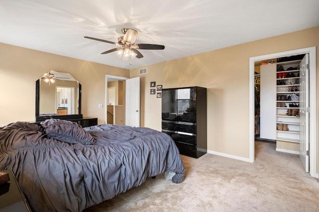 1754 Hightree Dr SW, Byron Center, MI 49315 - carpeted bedroom featuring a walk in closet, baseboards, and a ceiling fan