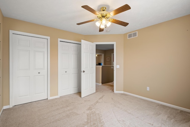1754 Hightree Dr SW, Byron Center, MI 49315 - unfurnished bedroom featuring multiple closets, light carpet, baseboards, and a ceiling fan