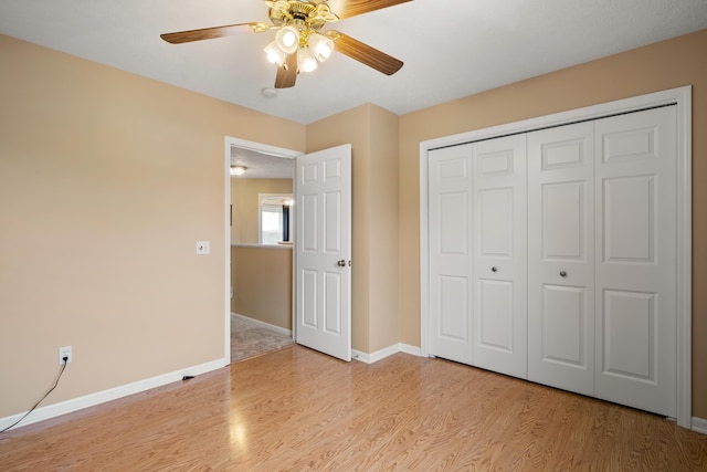 1754 Hightree Dr SW, Byron Center, MI 49315 - unfurnished bedroom featuring light wood-type flooring, a closet, baseboards, and a ceiling fan