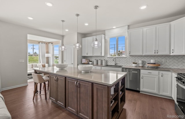 16136 Conifer Ln, Clinton Township, MI 48038 - kitchen with stainless steel appliances, dark wood-style flooring, backsplash, white cabinets, and recessed lighting