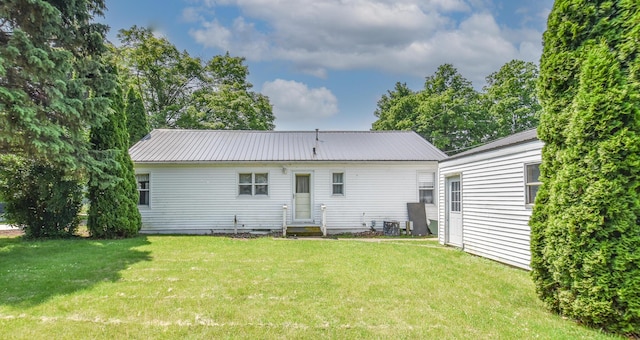 402 Division St, Union City, MI 49094 - back of house featuring a yard and metal roof