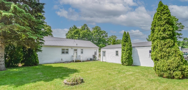 402 Division St, Union City, MI 49094 - back of property with a lawn, metal roof, and an outbuilding
