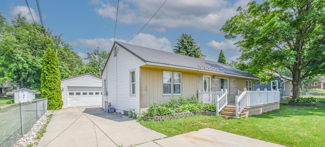 402 Division St, Union City, MI 49094 - bungalow-style house featuring an outbuilding, a garage, and metal roof