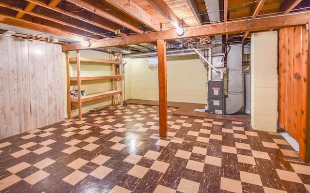 402 Division St, Union City, MI 49094 - unfinished below grade area with tile patterned floors, wood walls, heating unit, and water heater