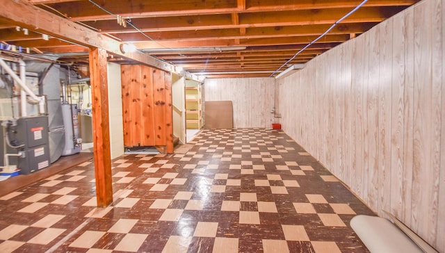 402 Division St, Union City, MI 49094 - unfinished below grade area with tile patterned floors, gas water heater, wooden walls, and heating unit