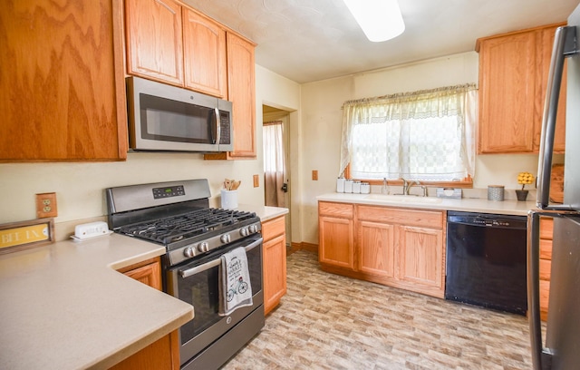 402 Division St, Union City, MI 49094 - kitchen with stainless steel appliances, a sink, light countertops, and baseboards