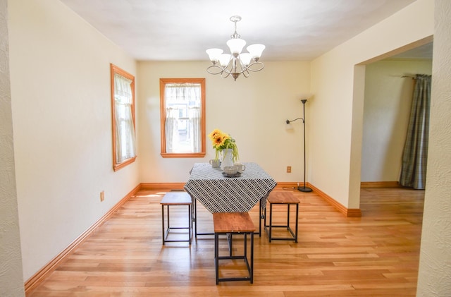 402 Division St, Union City, MI 49094 - dining area with a chandelier, light wood finished floors, and baseboards