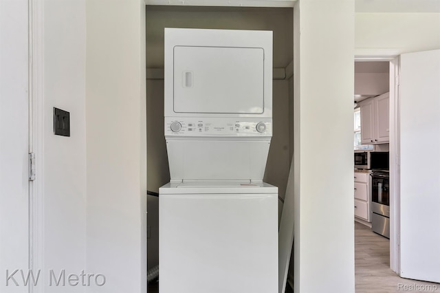 19391 Inkster Rd, Livonia, MI 48152 - laundry room with stacked washer / dryer and light wood-type flooring