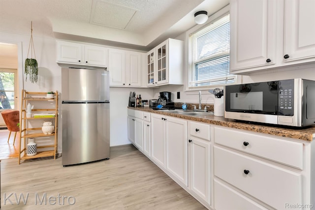 19391 Inkster Rd, Livonia, MI 48152 - kitchen featuring appliances with stainless steel finishes, a sink, plenty of natural light, and white cabinets