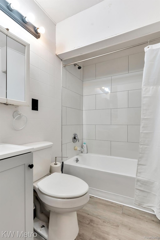 19391 Inkster Rd, Livonia, MI 48152 - bathroom featuring shower / bath combo with shower curtain, wood finished floors, vanity, toilet, and tile walls