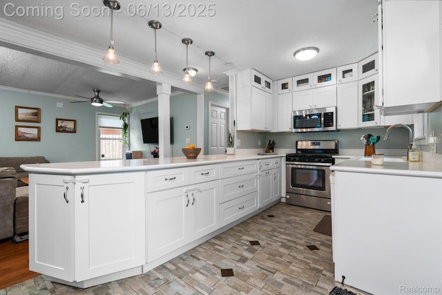 3341 Creek Dr, Ann Arbor, MI 48108 - kitchen featuring appliances with stainless steel finishes, open floor plan, ceiling fan, a peninsula, and white cabinetry