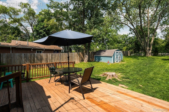 3341 Creek Dr, Ann Arbor, MI 48108 - deck featuring outdoor dining area, a fenced backyard, a storage unit, and view of wooded area