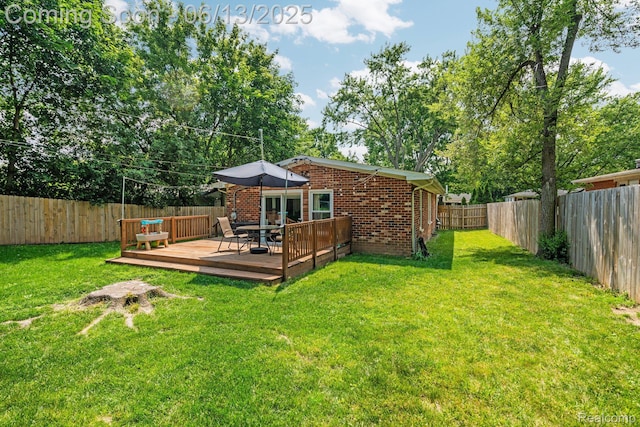 3341 Creek Dr, Ann Arbor, MI 48108 - rear view of property featuring a deck, brick siding, and a fenced backyard
