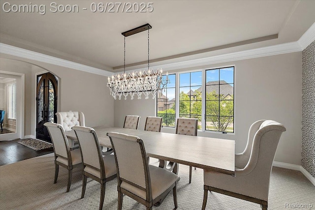 3610 Piccadilly Dr, Rochester Hills, MI 48309 - dining space with a raised ceiling, arched walkways, ornamental molding, wood finished floors, and a chandelier