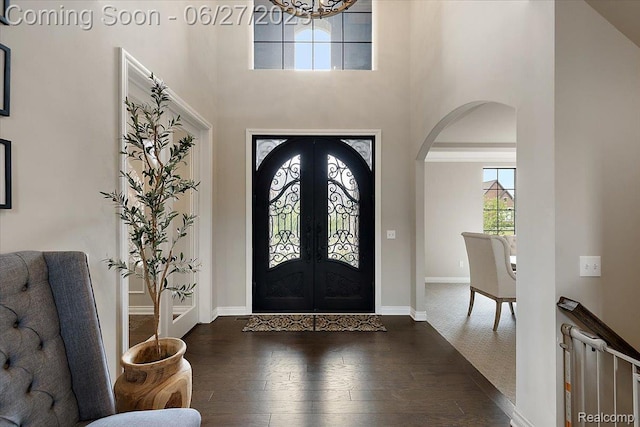 3610 Piccadilly Dr, Rochester Hills, MI 48309 - foyer with arched walkways, hardwood / wood-style floors, french doors, a chandelier, and a high ceiling