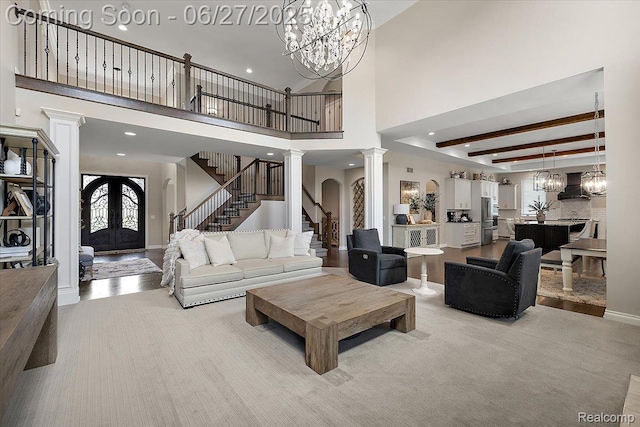 3610 Piccadilly Dr, Rochester Hills, MI 48309 - living area with ornate columns, french doors, a chandelier, stairway, and a high ceiling