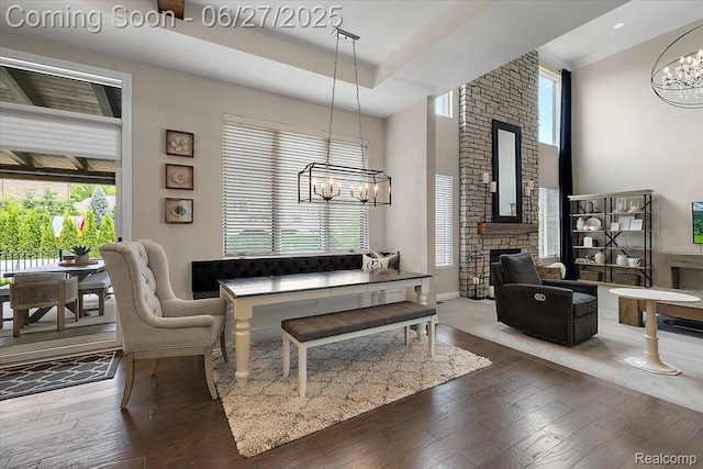 3610 Piccadilly Dr, Rochester Hills, MI 48309 - living area with a chandelier, wood finished floors, a fireplace, healthy amount of natural light, and a high ceiling