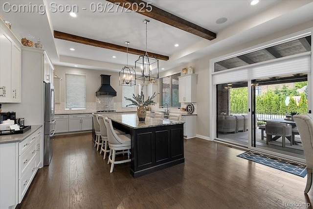 3610 Piccadilly Dr, Rochester Hills, MI 48309 - kitchen featuring a kitchen island, custom exhaust hood, beam ceiling, dark wood finished floors, and decorative backsplash