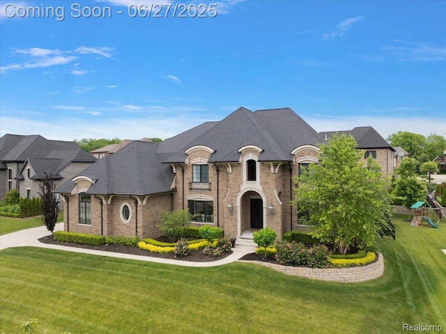3610 Piccadilly Dr, Rochester Hills, MI 48309 - french provincial home featuring a front yard, brick siding, and a playground