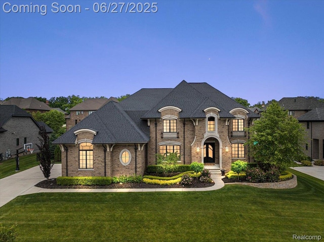 3610 Piccadilly Dr, Rochester Hills, MI 48309 - french provincial home featuring a front lawn, brick siding, roof with shingles, and concrete driveway