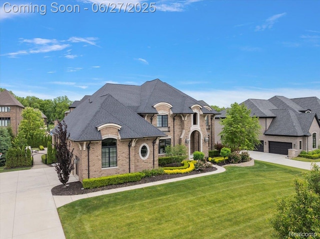 3610 Piccadilly Dr, Rochester Hills, MI 48309 - french country style house featuring driveway, a front yard, brick siding, roof with shingles, and an attached garage